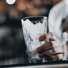 A tall glass on the counter ready to serve ice and beverages