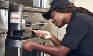Hobart Service employee on a job repairing commercial kitchen equipment