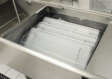 Turbowash powered sink sheet pan rack in use.